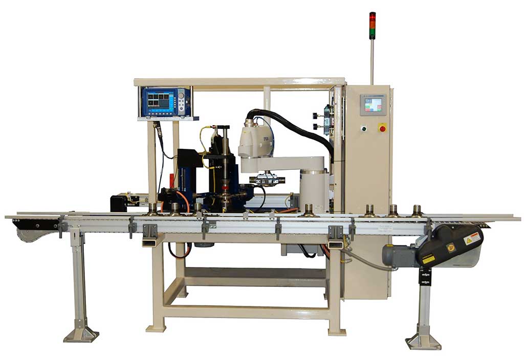 Machine that tests automotive spindles for surface cracks using eddy current probes